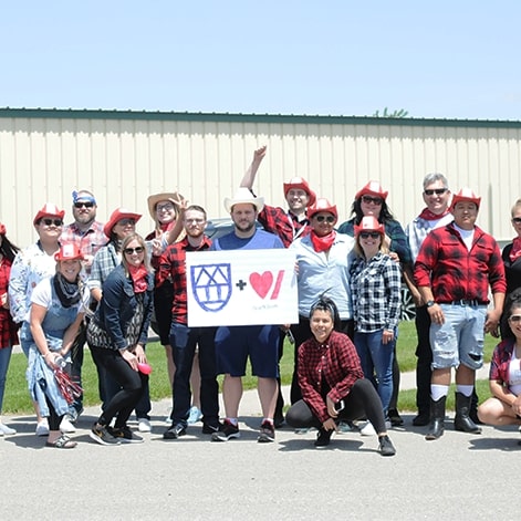 ZucoraHome employees with big bike challenge poster in the hand.