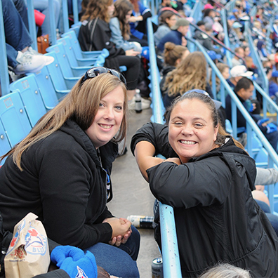 Employess enjoying and smiling at Jays game day.