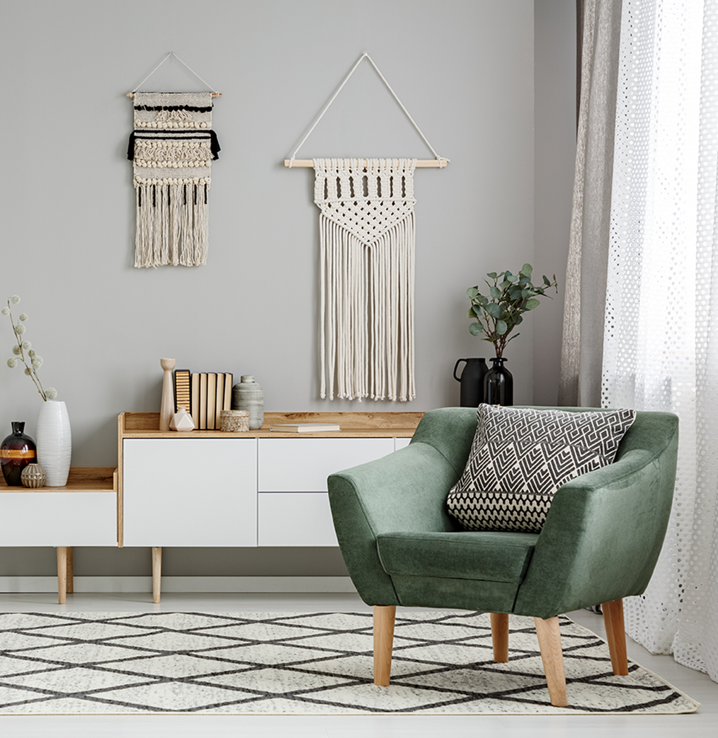 comfortable-looking velvet chair by a window in a contemporary, organized living room